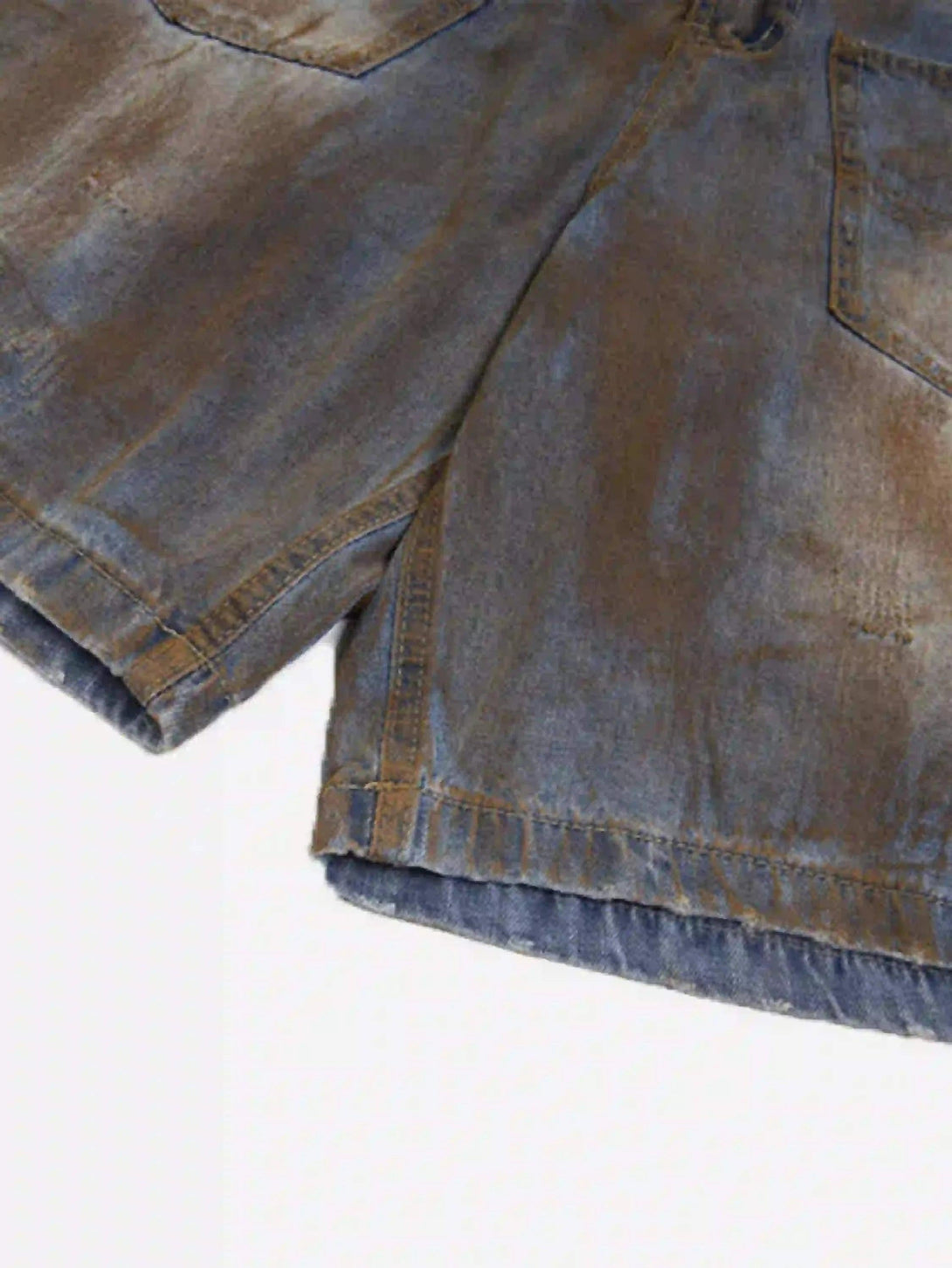 A detailed view of TALISHKO's wide-leg denim jorts, highlighting the rugged texture.