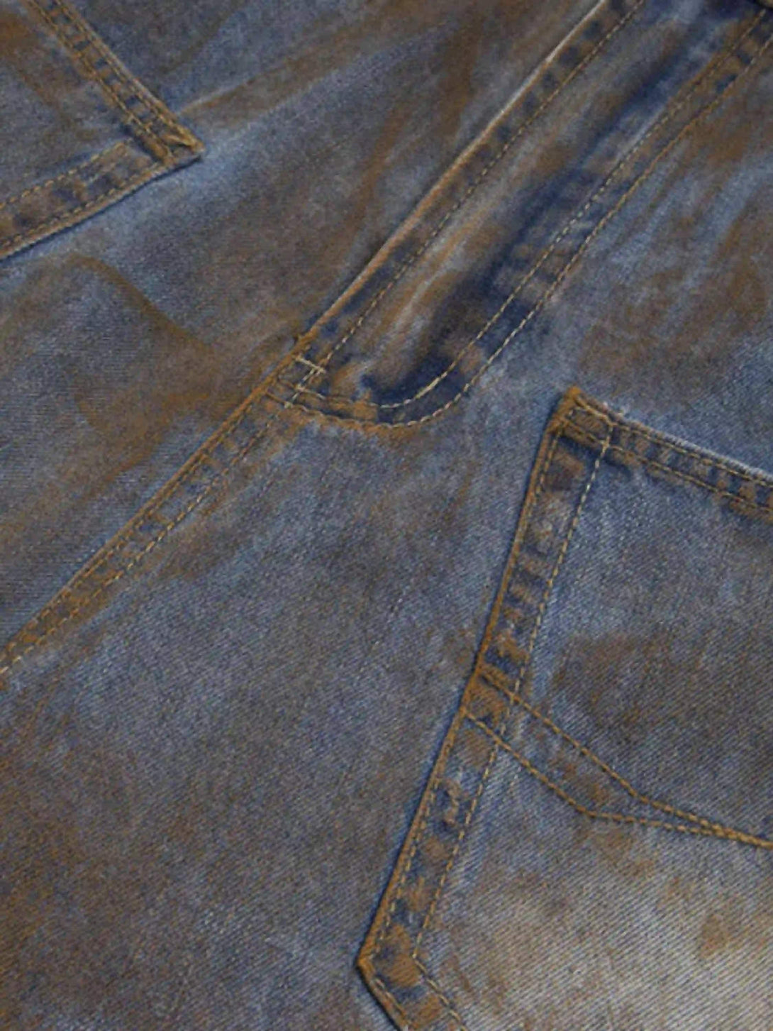 Texture and pattern showcased in TALISHKO's wide-leg denim jorts, highlighting a worn look.