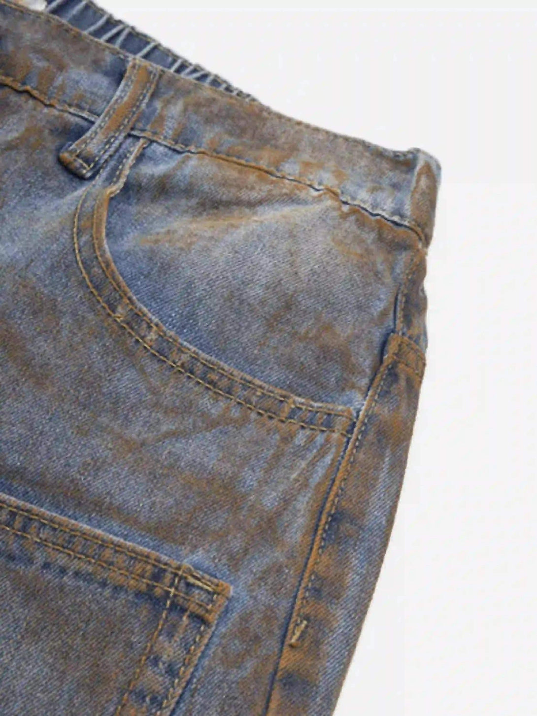 Detailed fabric and stitching of TALISHKO's wide-leg denim jorts, emphasizing a rugged look.