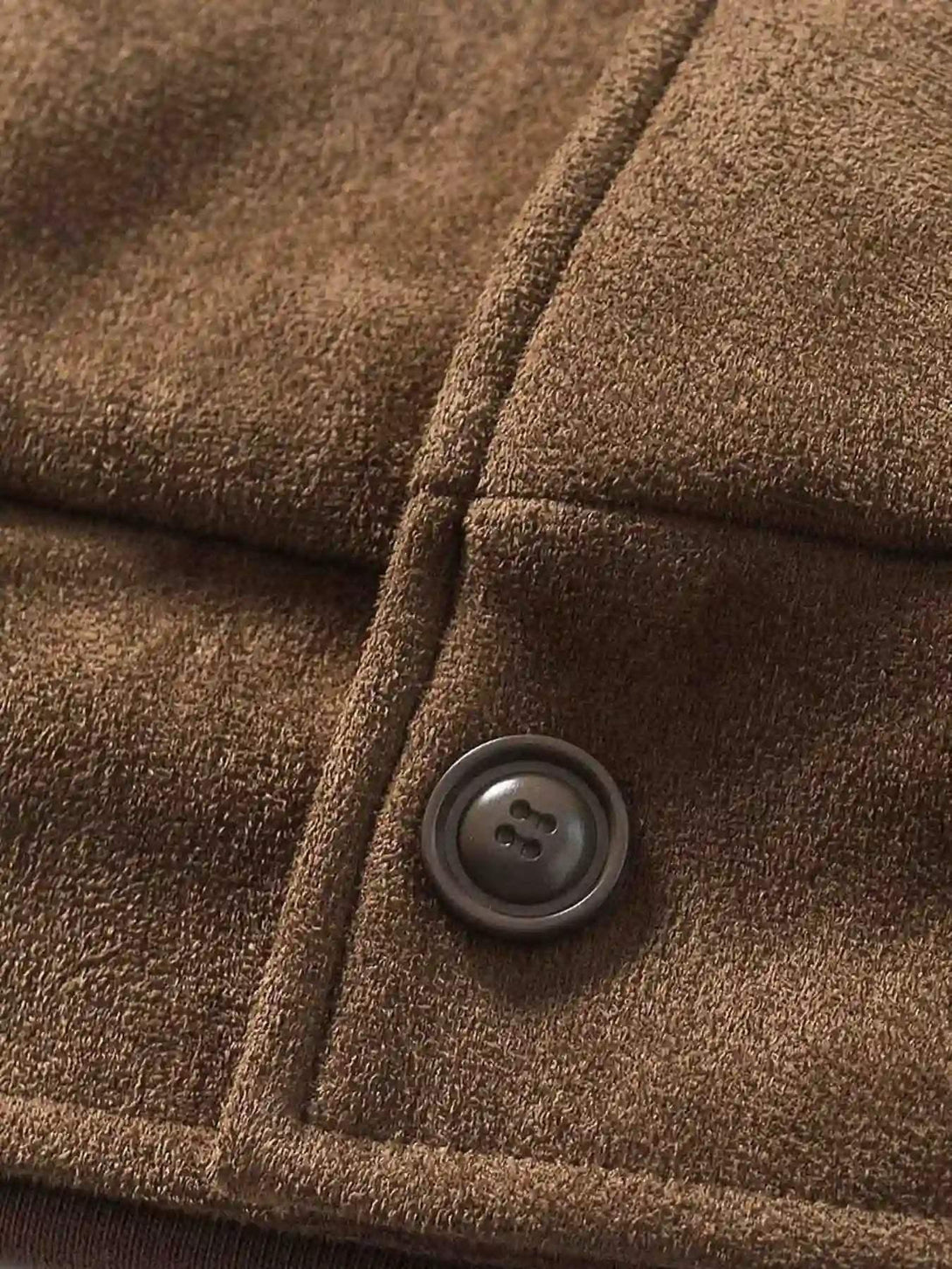 Detailed fabric and button design of a brown patchwork jacket by TALISHKO.