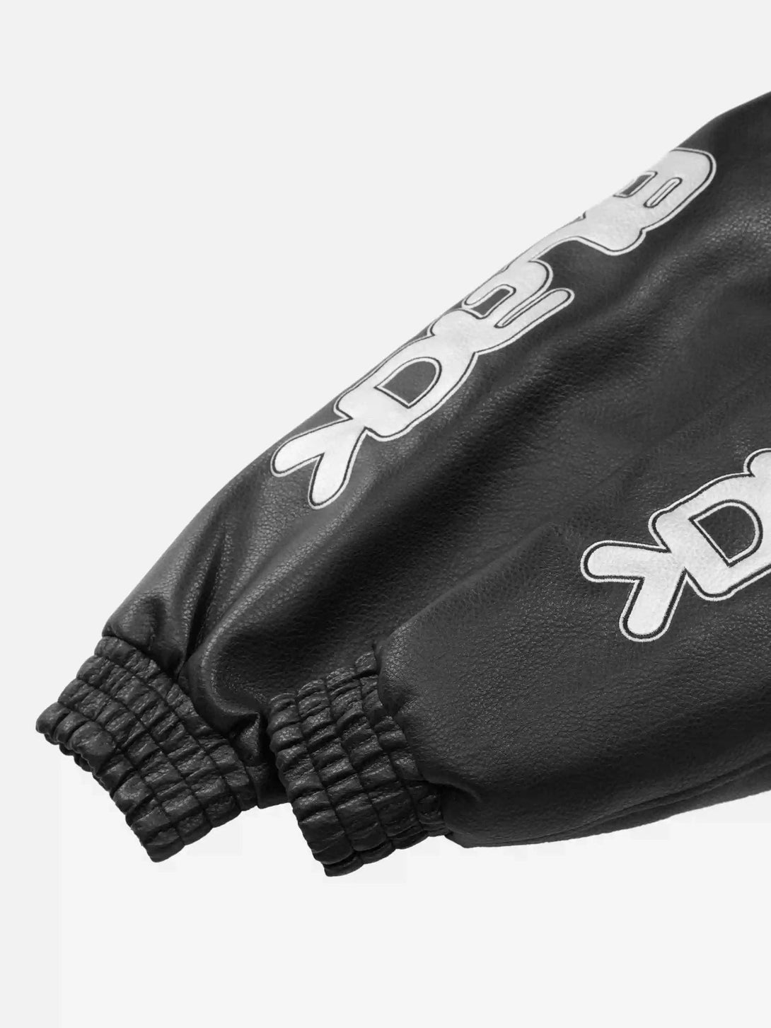 Intricate look at TALISHKO's PU leather jacket sleeve, featuring bold street-style graphics.
