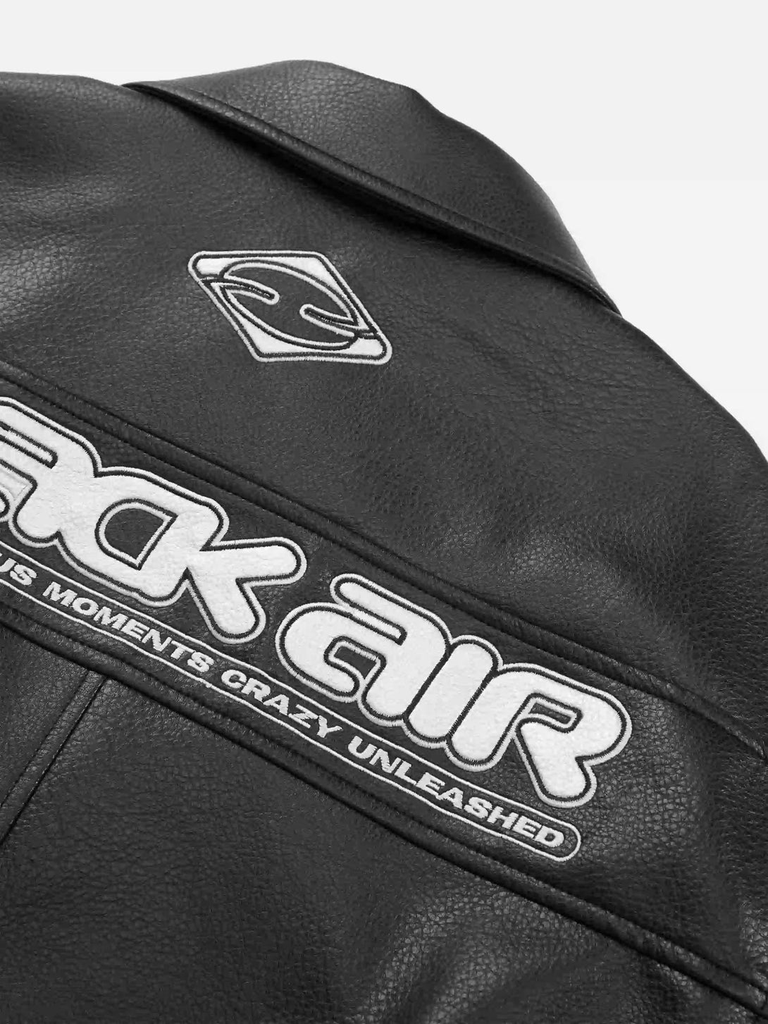 Zoomed-in view of TALISHKO's PU leather jacket, showcasing bold graphic details on the back.