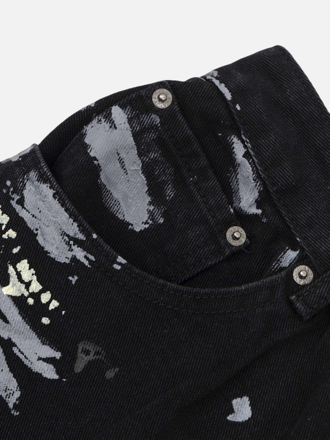 A detailed view of TALISHKO jeans with a bold graffiti print and artistic pattern.
