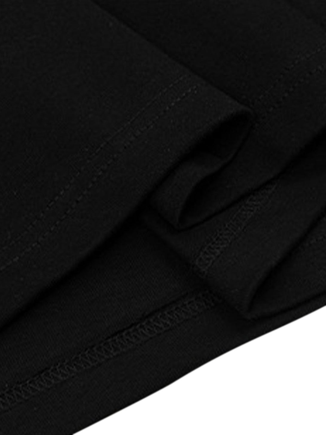 Detailed fabric and stitching of a black oversized T-shirt by TALISHKO, highlighting quality.