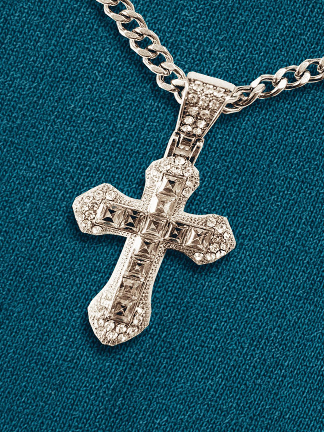 A close-up of TALISHKO's intricate cross pendant on a chain, highlighting its elegant design.