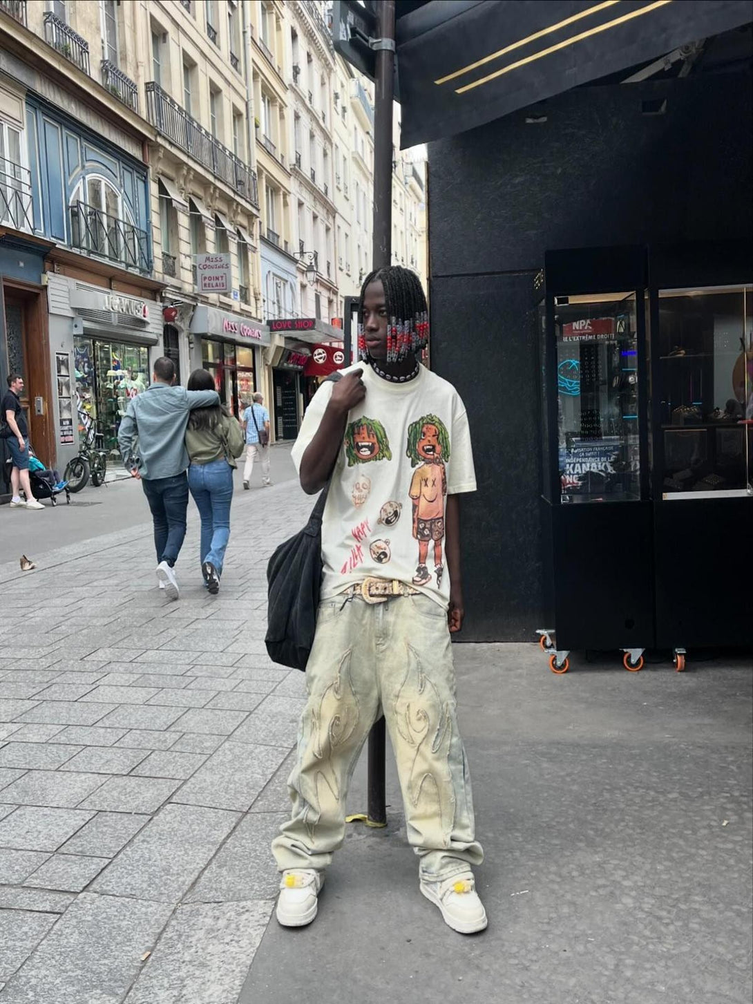 Trendy anime character printed T-shirt by TALISHKO, worn with stylish jeans and sneakers.