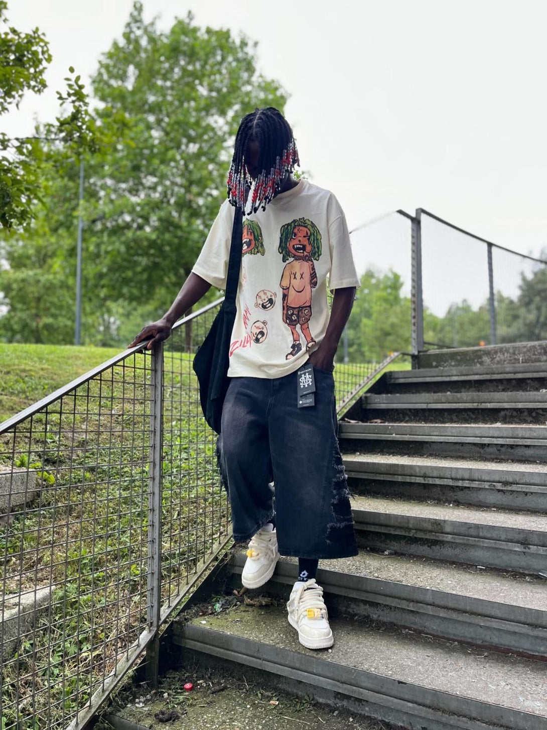 Stylish anime character T-shirt by TALISHKO, paired with wide-leg jeans and sneakers.