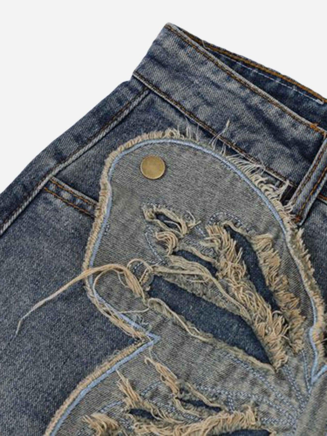 A close-up of TALISHKO jeans highlights intricate butterfly appliqué and distressed details.