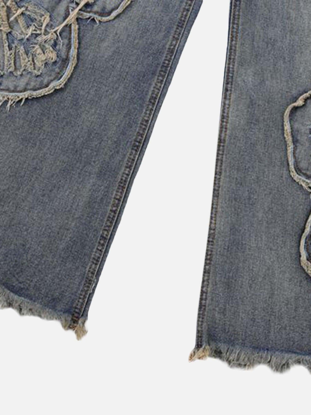 Focusing on TALISHKO jeans' frayed hems and appliqued butterfly detail for a unique touch.