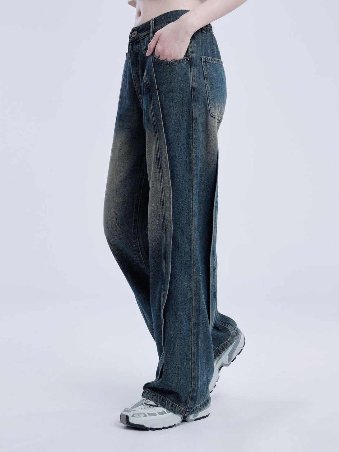 Model in TALISHKO arc patchwork jeans, highlighting the wide leg and casual style.