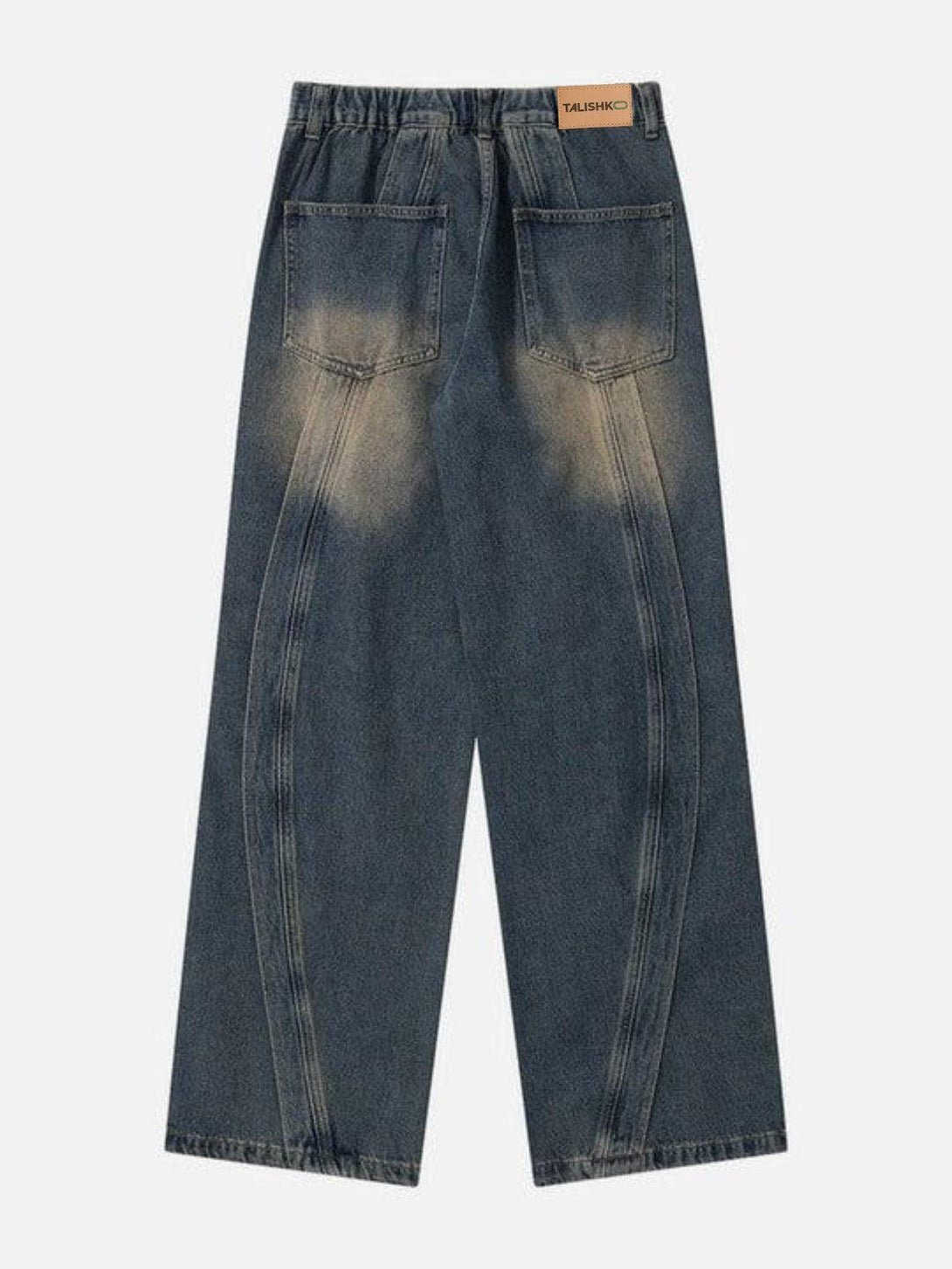 Back view of TALISHKO arc patchwork jeans, highlighting unique stitching and pocket design.
