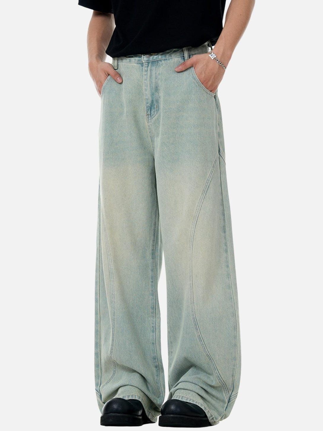 TALISHKO loose jeans with arc patchwork, showcasing a relaxed fit and casual style.