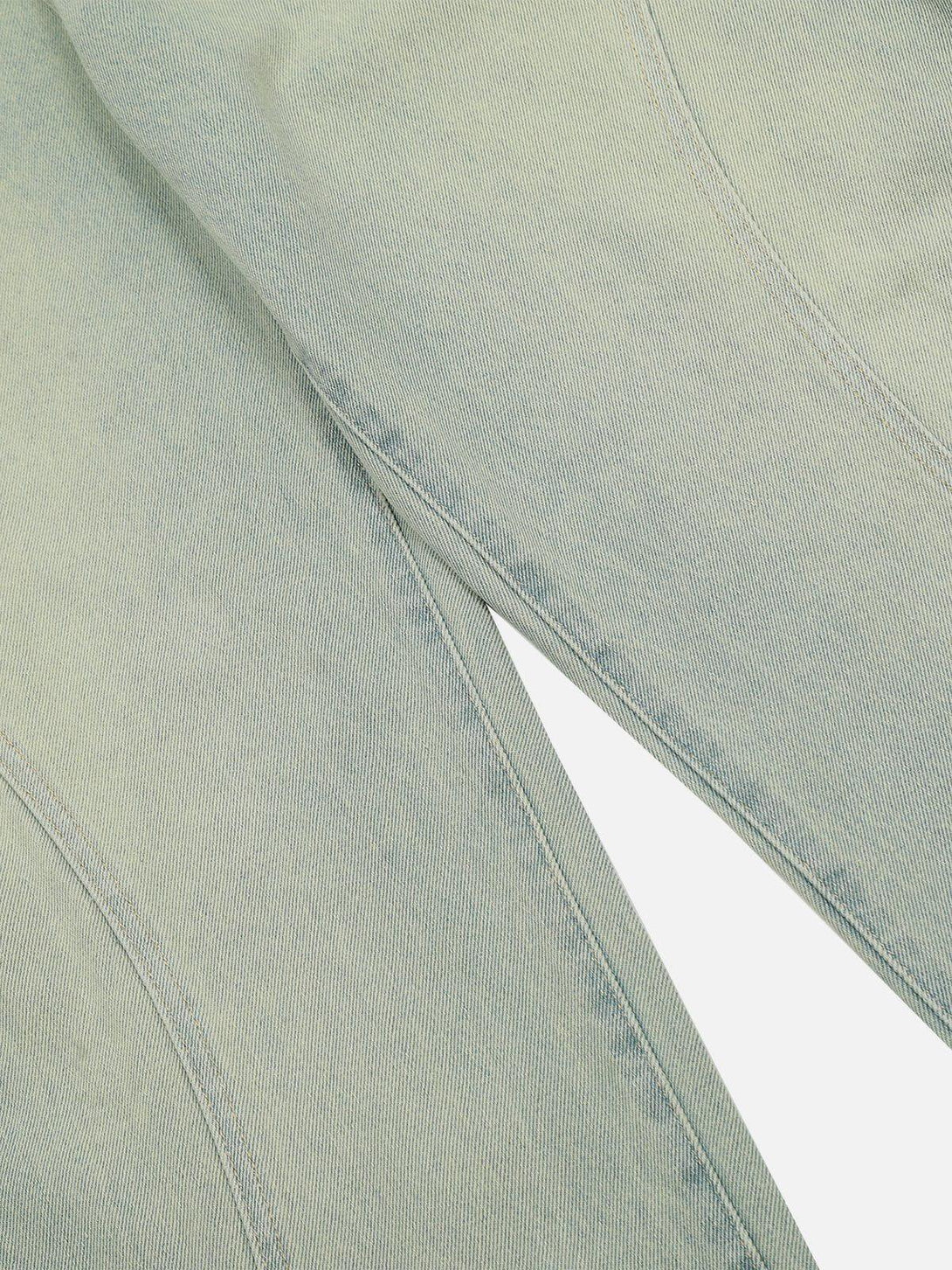 Intricate look at TALISHKO arc patchwork with washed texture, highlighting unique denim design.