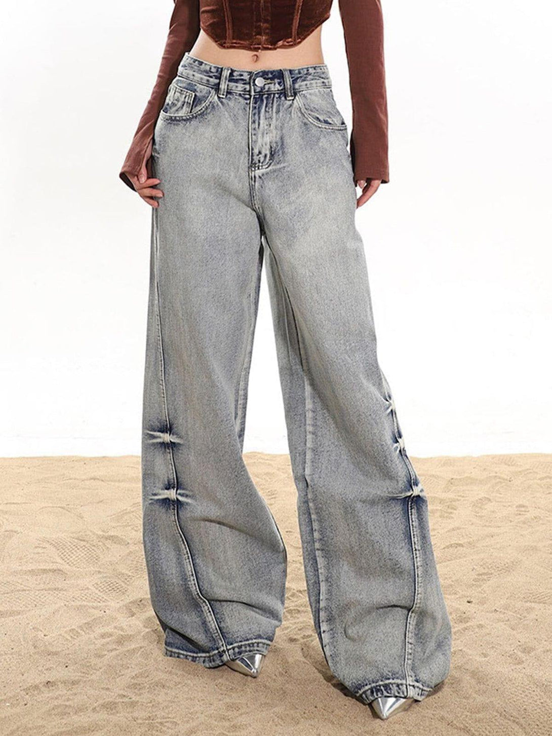 Model wearing TALISHKO arc-stitched washed jeans, showcasing a relaxed, wide-leg fit.