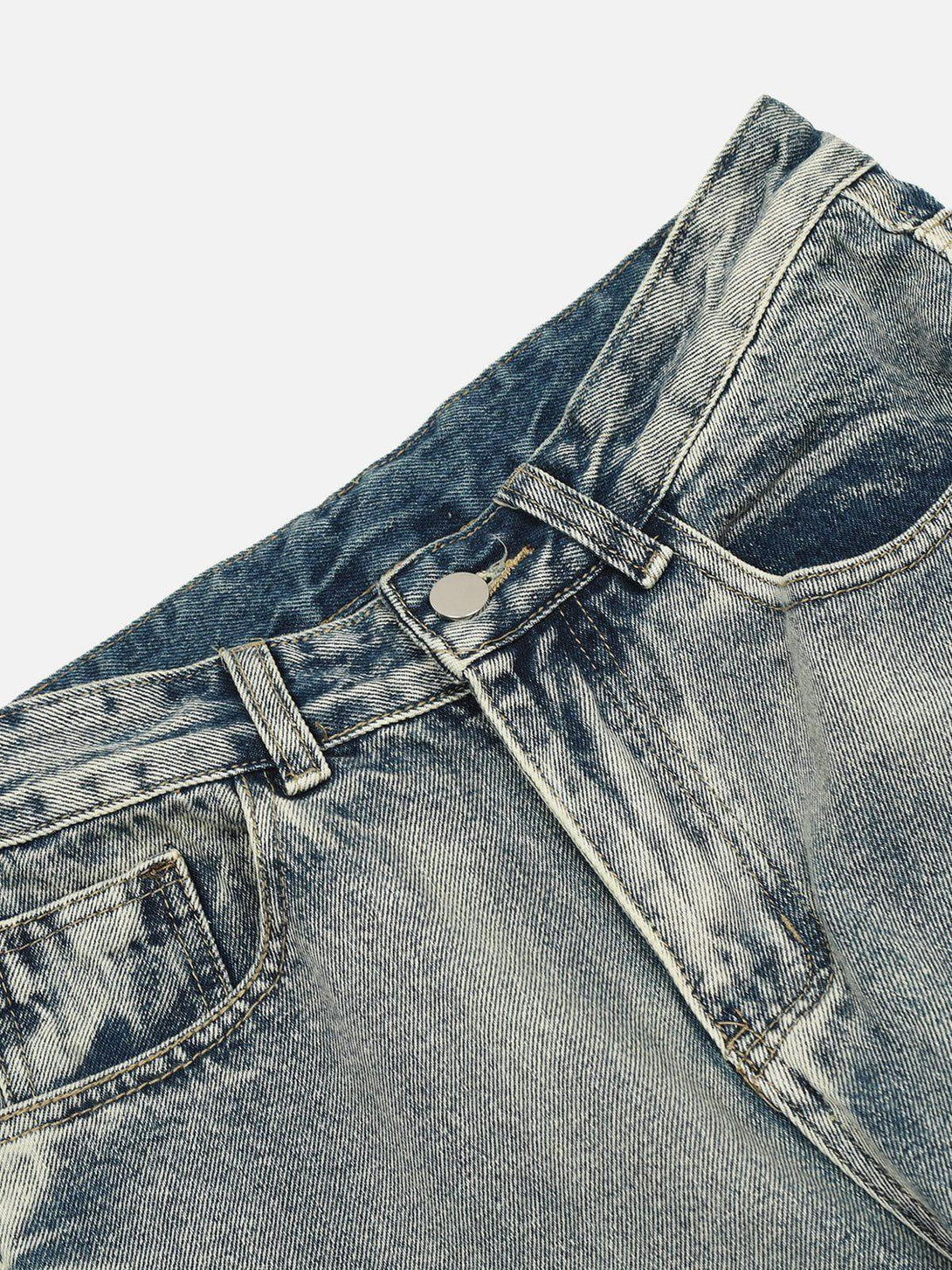 Detailed view of TALISHKO arc-stitched washed jeans, highlighting unique texture and stitching.