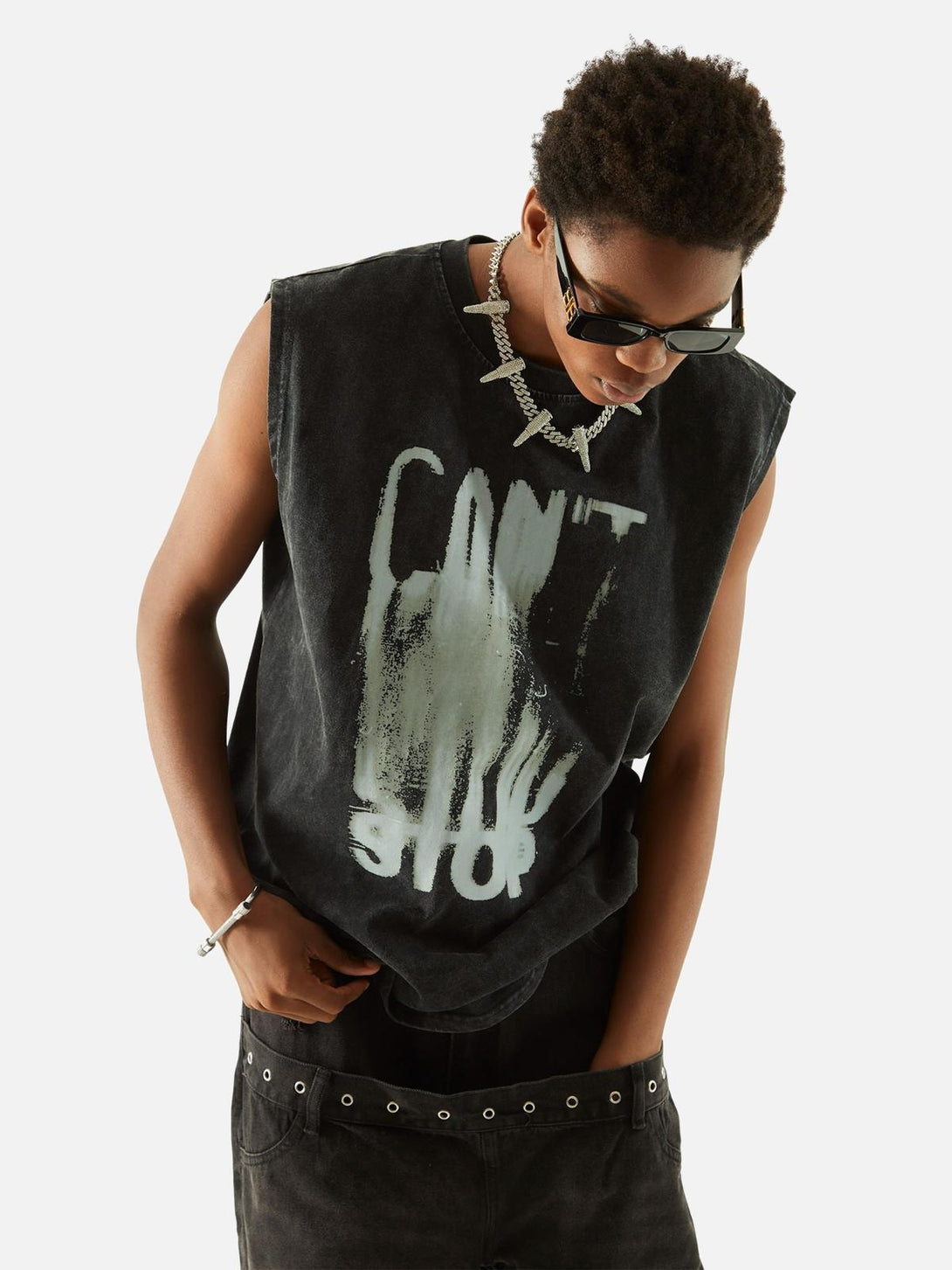 Model in a TALISHKO washed vest with bold lettering, accessorized with a statement necklace.