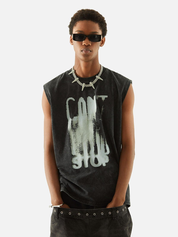 Model wearing a distressed vest with bold lettering, styled by TALISHKO, exuding urban flair.
