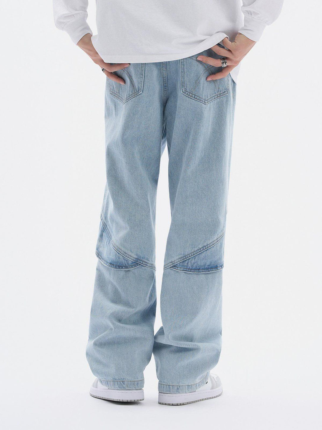 Back view of TALISHKO artistic cut jeans, highlighting unique seam details and relaxed fit.