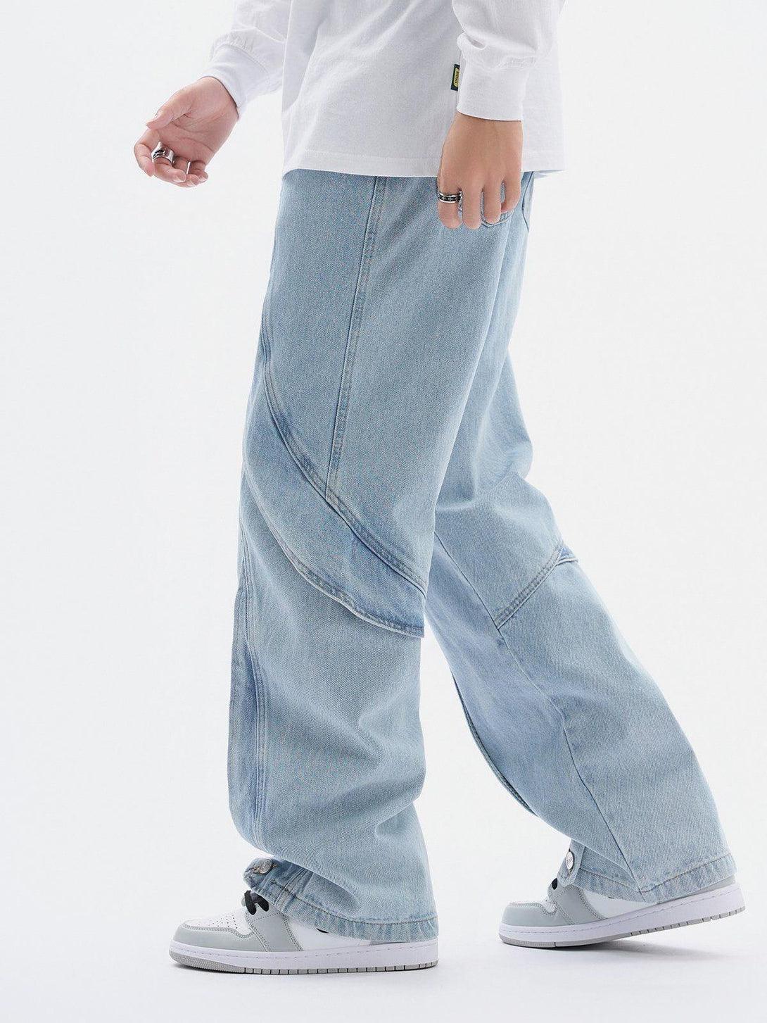 Side view of TALISHKO artistic cut jeans, featuring a relaxed fit and distinctive seam design.