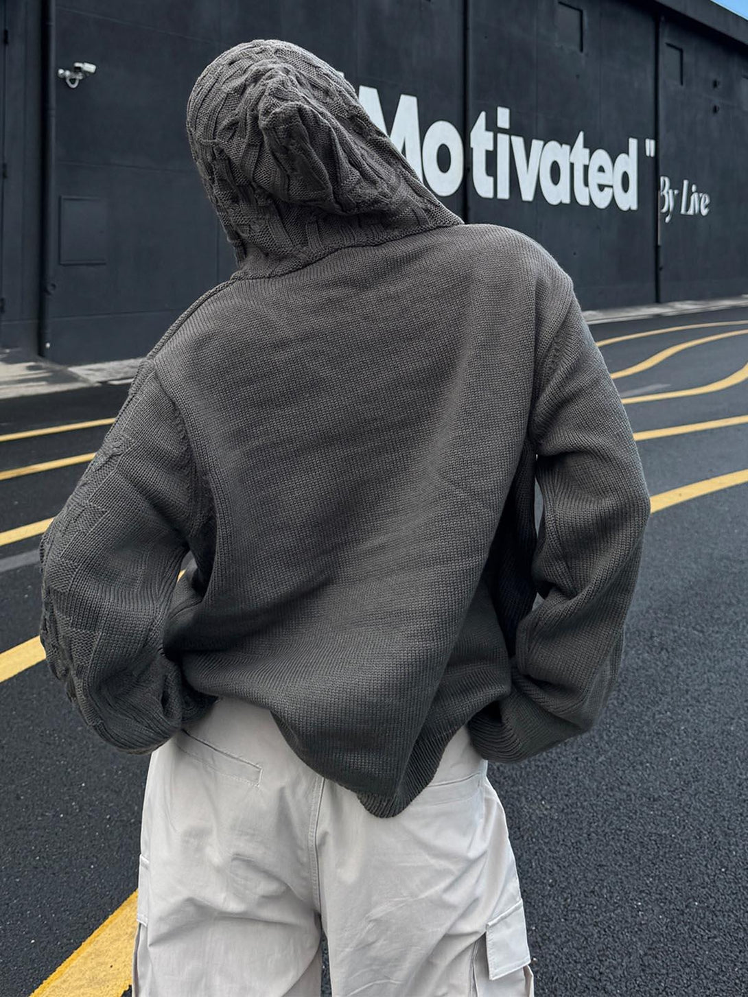 Back view of TALISHKO asymmetric knitted sweater hoodie, highlighting its distinct texture.
