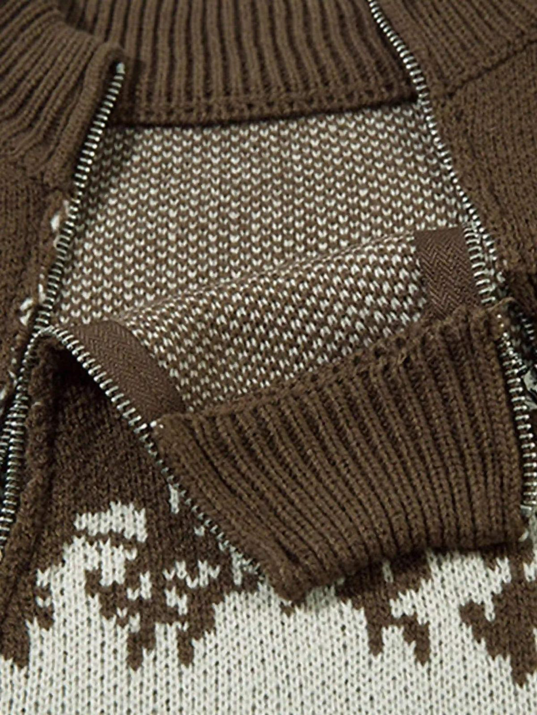 Intricate design detail from a TALISHKO sweater featuring jacquard stitching and a two-way zipper.