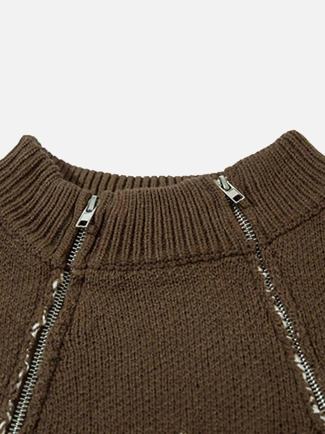 A detailed look at the TALISHKO sweater's two-way zipper and intricate jacquard stitching.