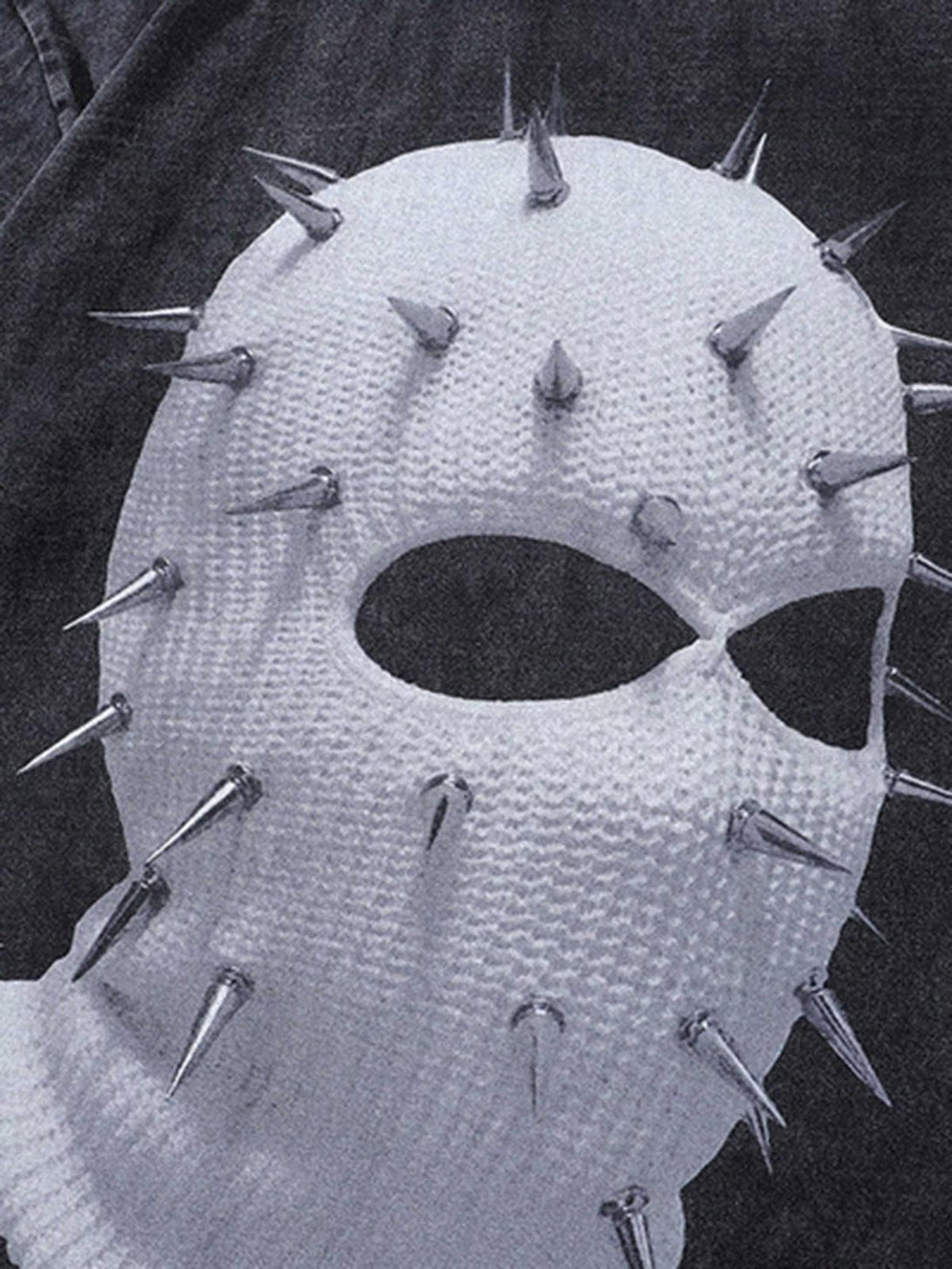 A striking TALISHKO design with a spiked mask graphic on a textured T-shirt.