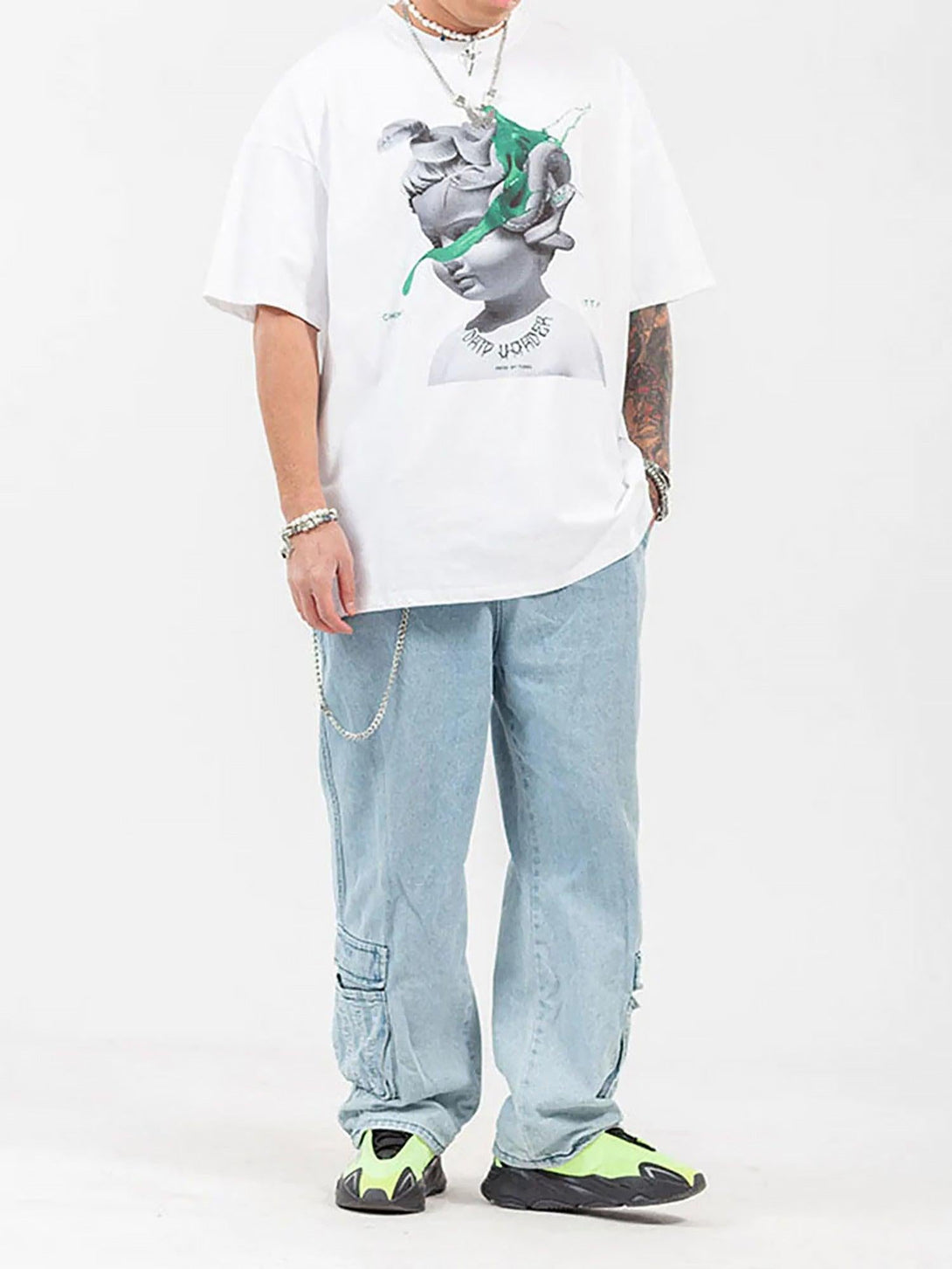 Model wearing a TALISHKO graphic printed T-shirt with casual jeans and vibrant sneakers.