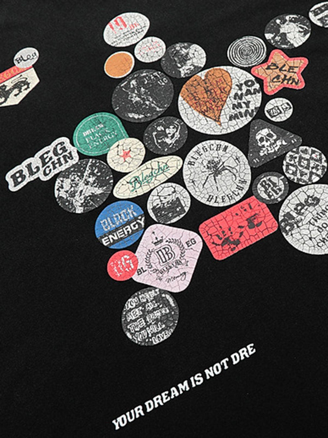 Badge print detail on TALISHKO T-shirt, emphasizing unique design and texture.