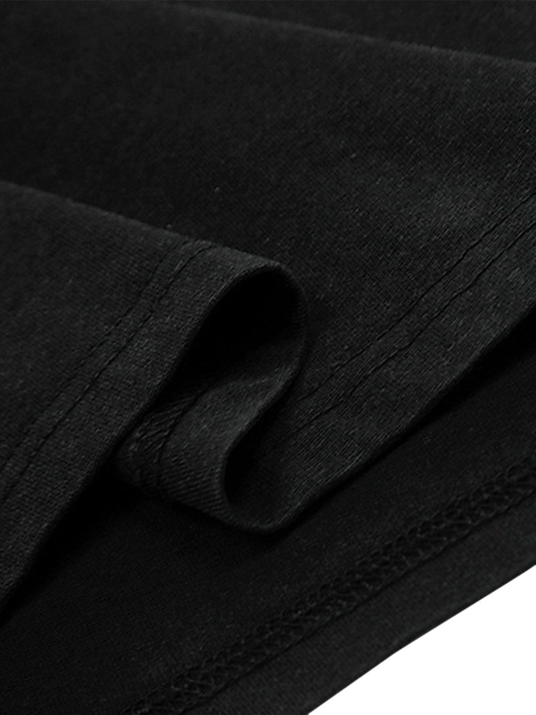 Intricate look at TALISHKO T-shirt's black fabric and stitching, highlighting quality craftsmanship.