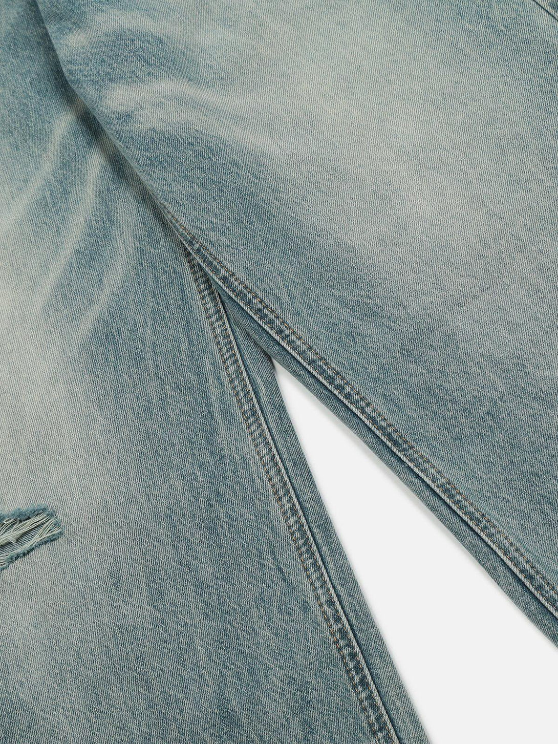 Detailed fabric and stitching of TALISHKO's distressed loose jeans, highlighting worn-in texture.