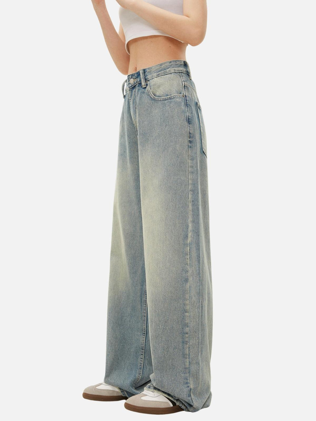 Model in TALISHKO loose jeans, highlighting a wide-leg silhouette and relaxed fashion.