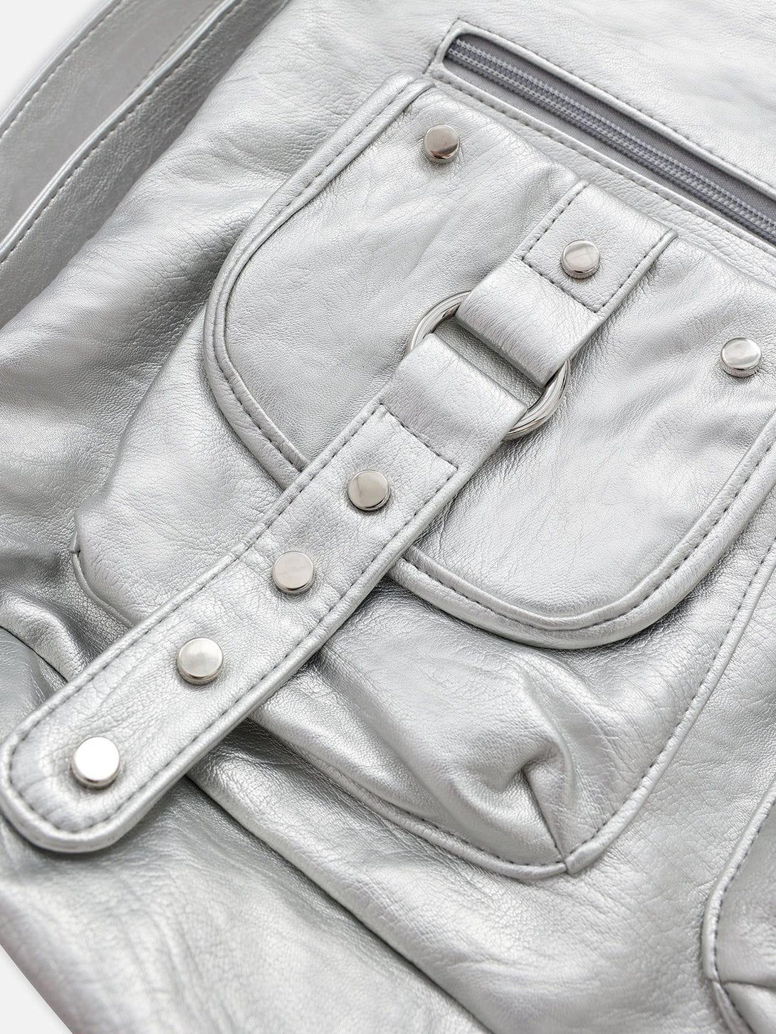 Intricate look at TALISHKO faux leather bag detailing, highlighting multiple front pockets.
