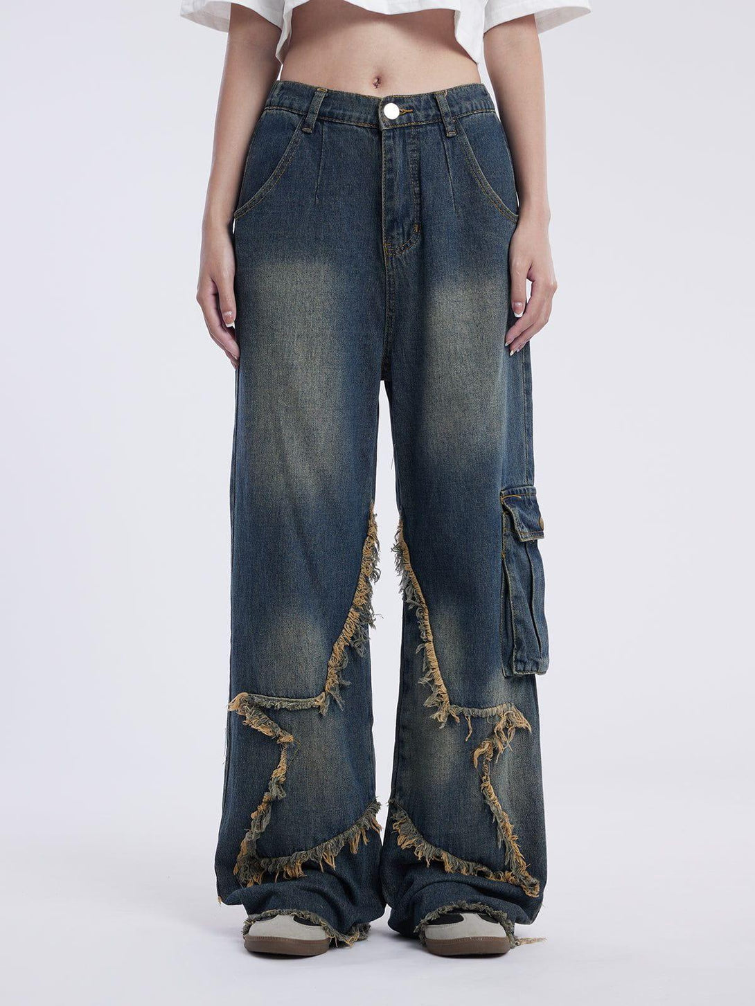 A model wearing TALISHKO's star-fringed loose jeans, highlighting a distinctive design.