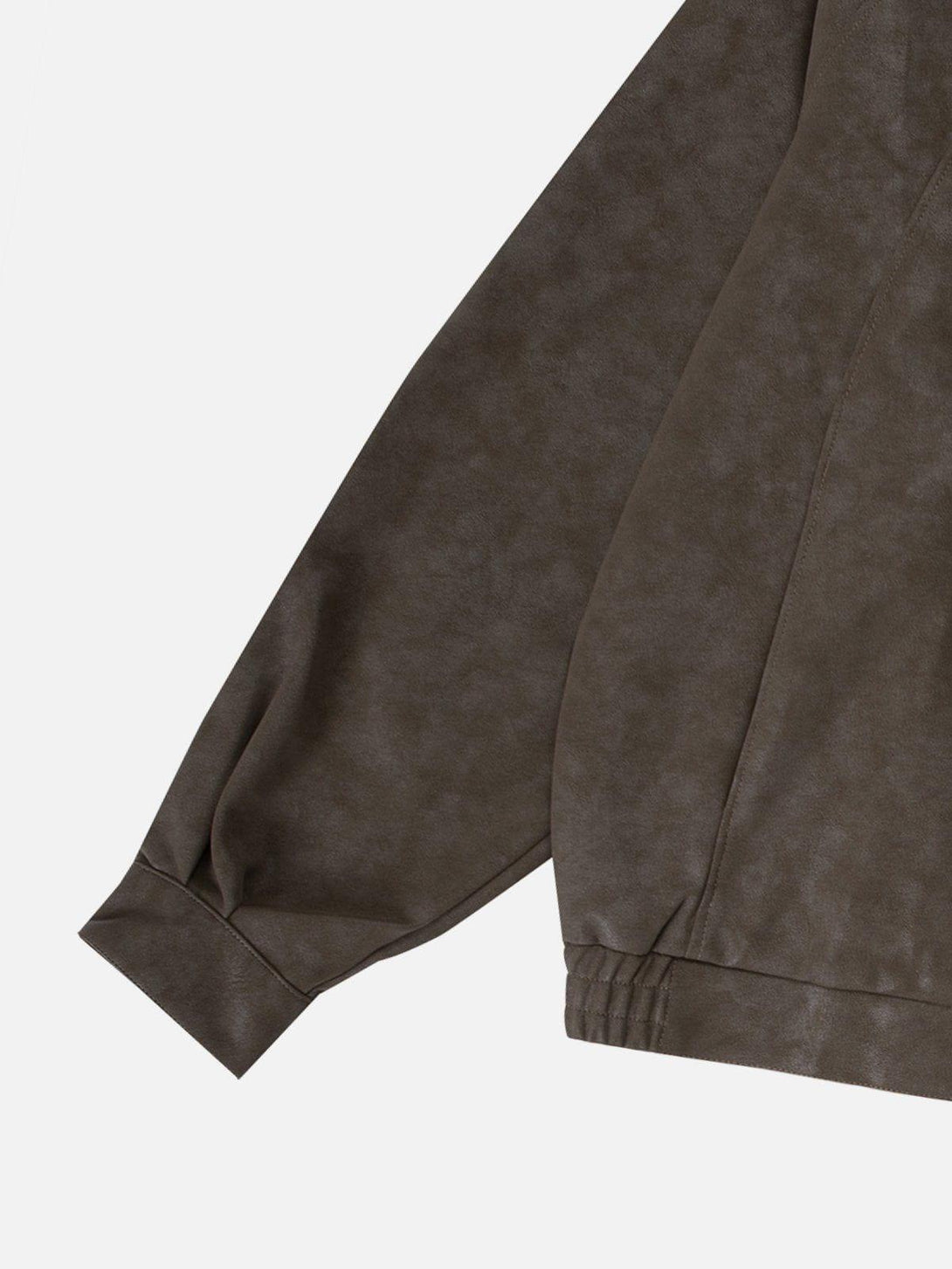 A detailed view of TALISHKO's faux leather jacket sleeve, highlighting the texture and stitching.