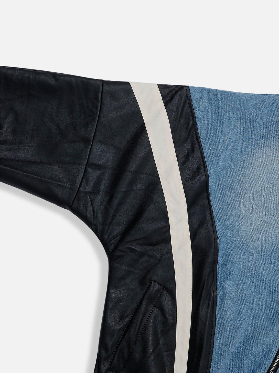 A close-up of TALISHKO's batwing sleeves jacket, highlighting faux leather and denim contrast.