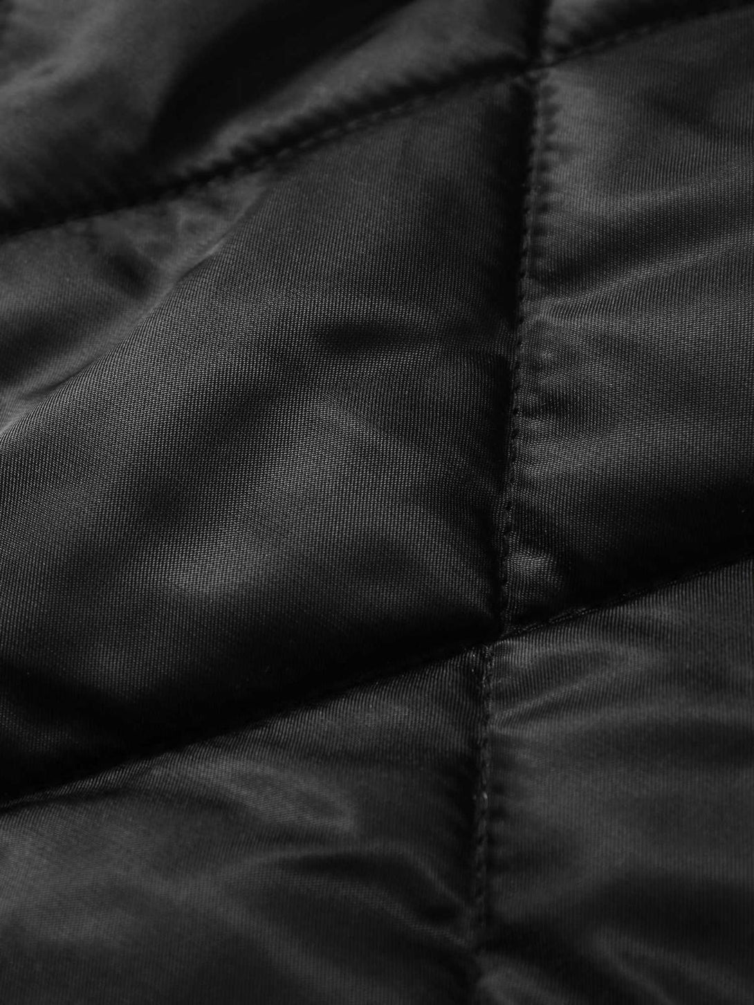 Detailed fabric and stitching of a padded jacket, showcasing TALISHKO's craftsmanship.