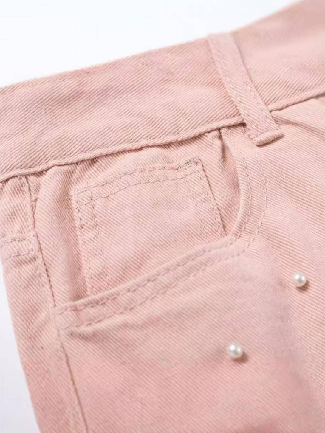A detailed look at the pink beaded pocket design on TALISHKO straight jeans, showcasing chic style.