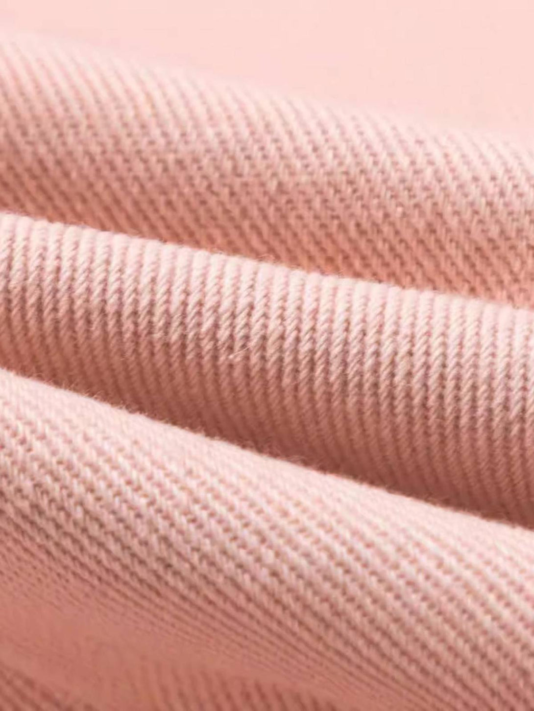 A close-up of pink fabric texture by TALISHKO, highlighting intricate detailing and quality.