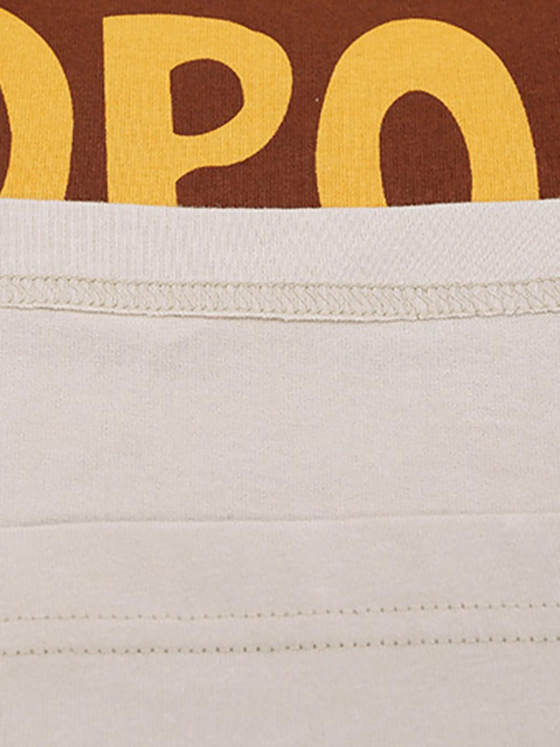 Intricate look at TALISHKO T-shirt stitching, highlighting the bold bear and letter print design.