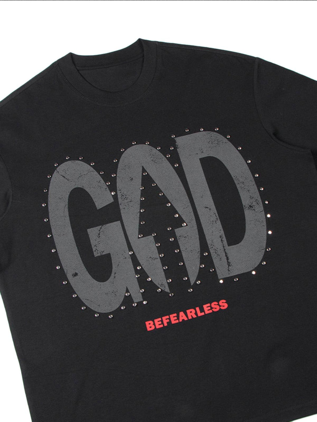 A close-up of the black TALISHKO "BEFEARLESS" T-shirt featuring bold graphics and studded details.