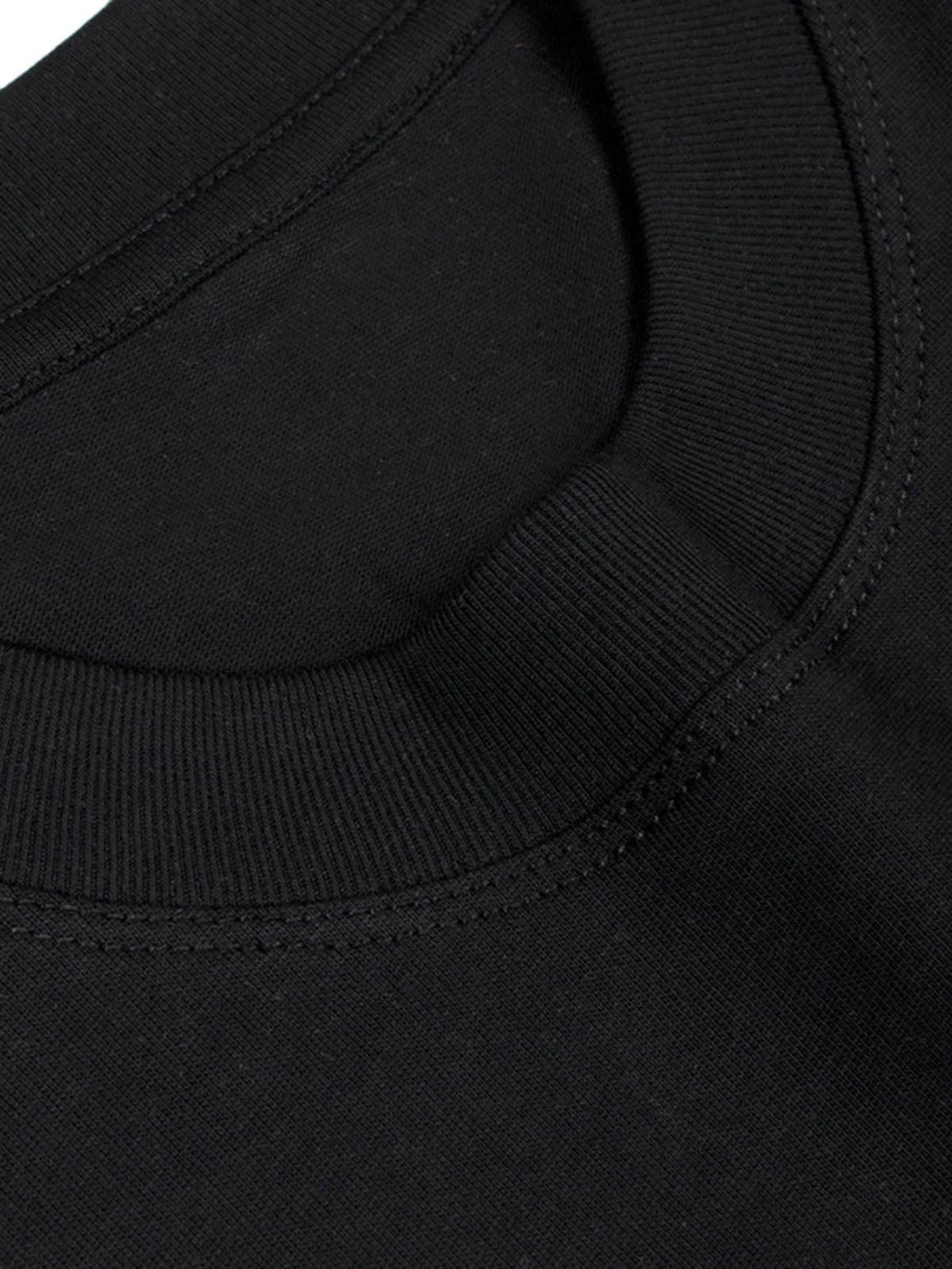 A close-up of the TALISHKO T-shirt's neckline, highlighting its smooth black fabric and stitching.