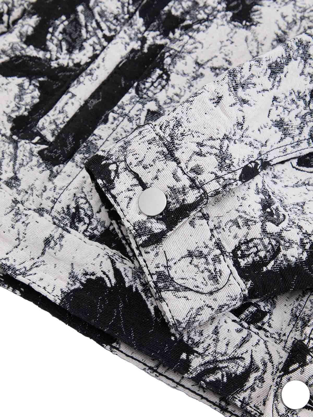 Intricate look at the black and white floral pattern on TALISHKO's denim jacket cuff.