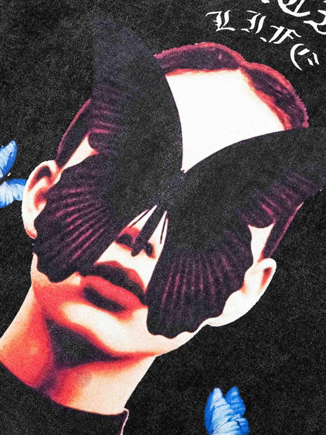 A detailed view of TALISHKO's black T-shirt, featuring a striking butterfly design over a face.