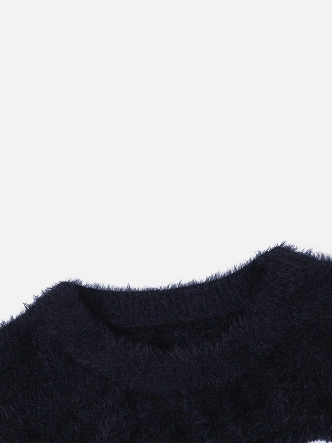 Fuzzy texture detail of TALISHKO's black sweater, capturing its stylish and cozy appeal.