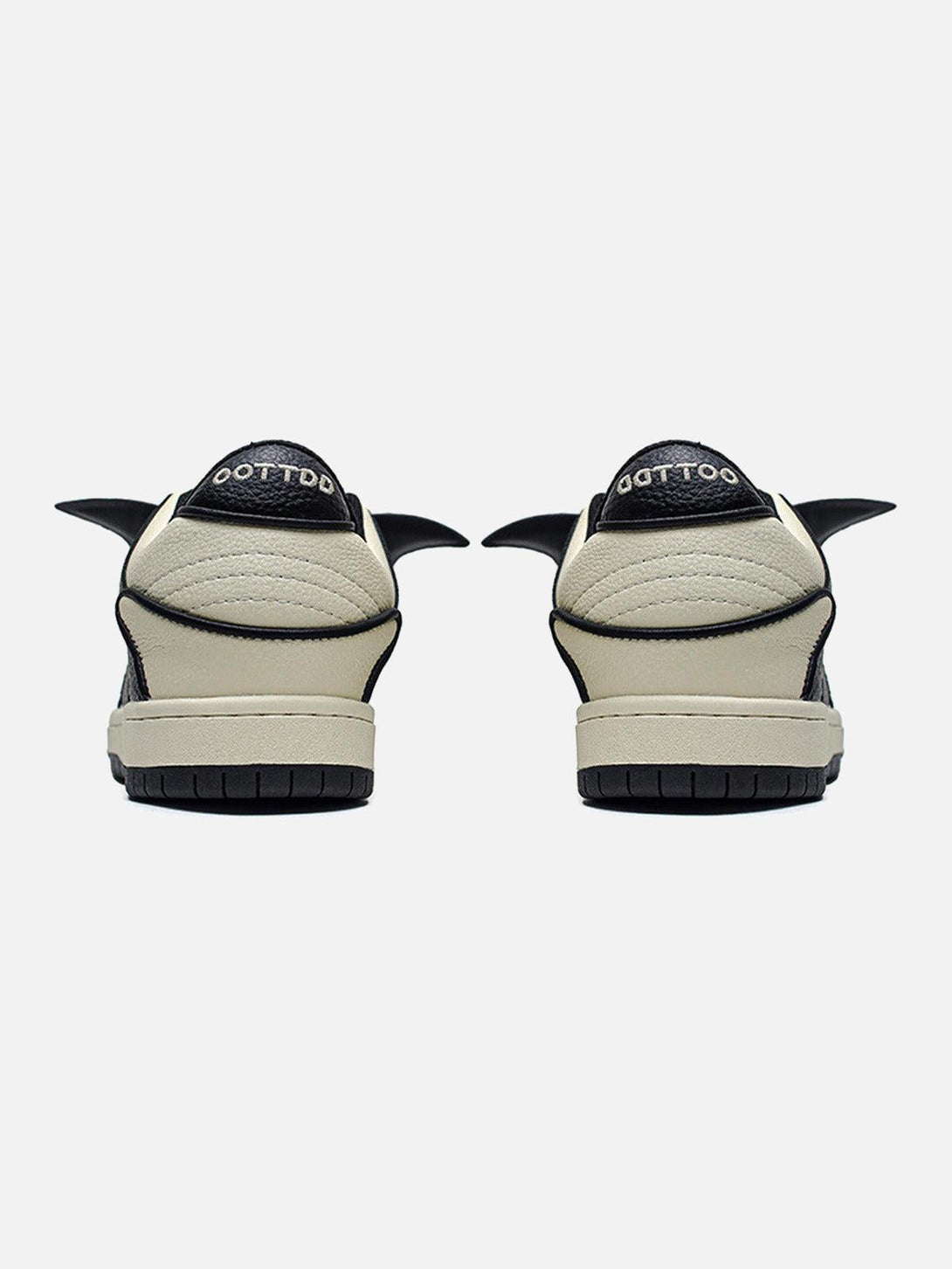 Rear view of TALISHKO black and white skate shoes showcasing unique wing-like design.