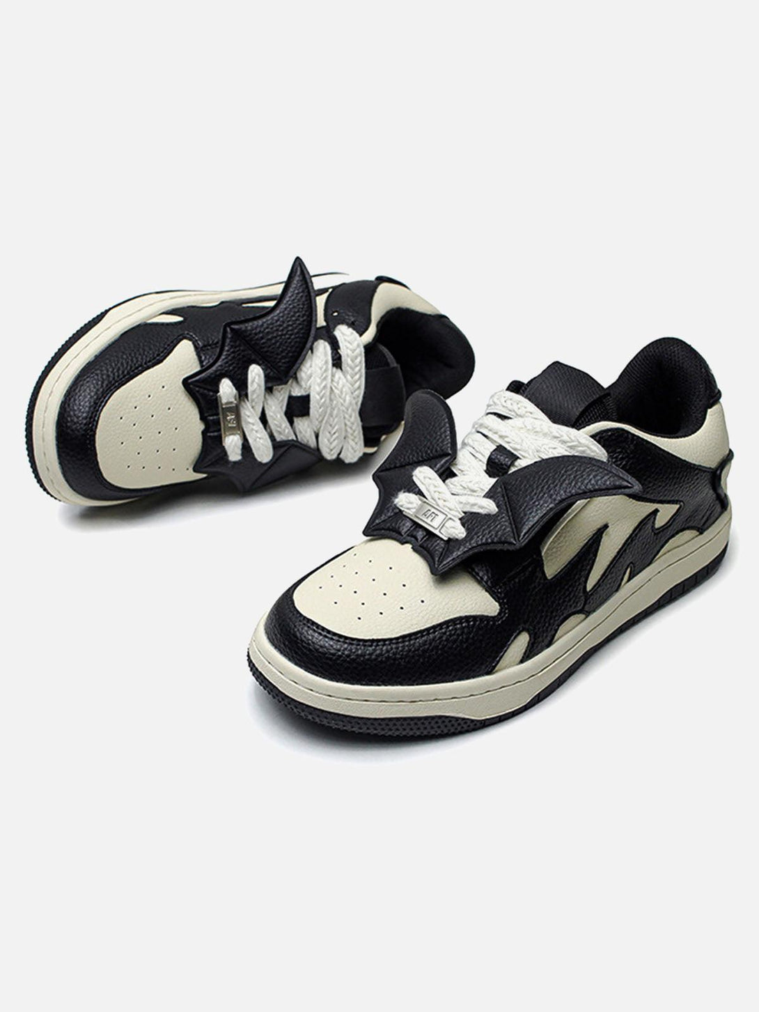 Black and white skate shoes by TALISHKO, featuring striking contrast and unique design details.