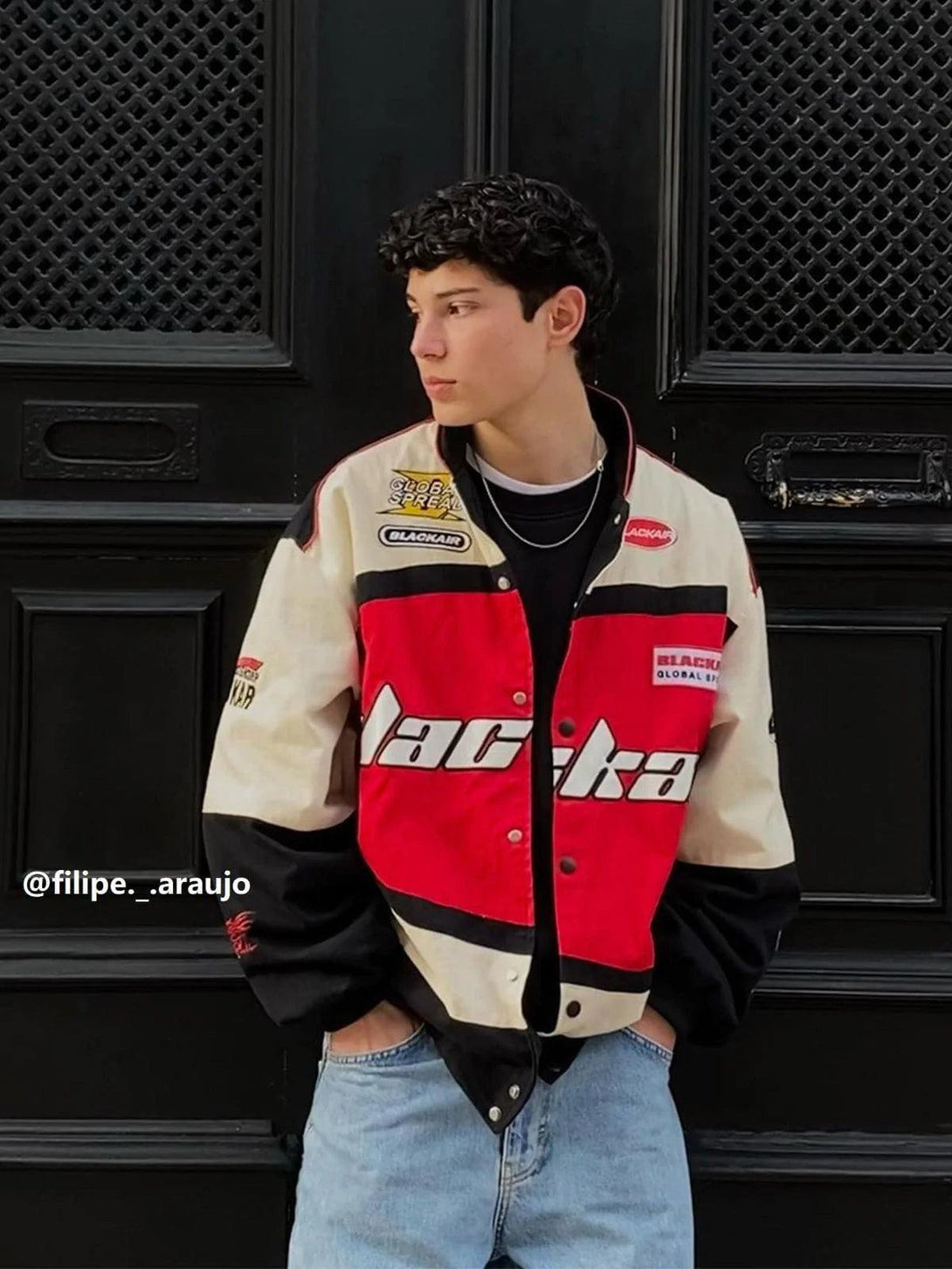 Model in TALISHKO BLACKAIR Motosports Jacket with a stylish red and black design.