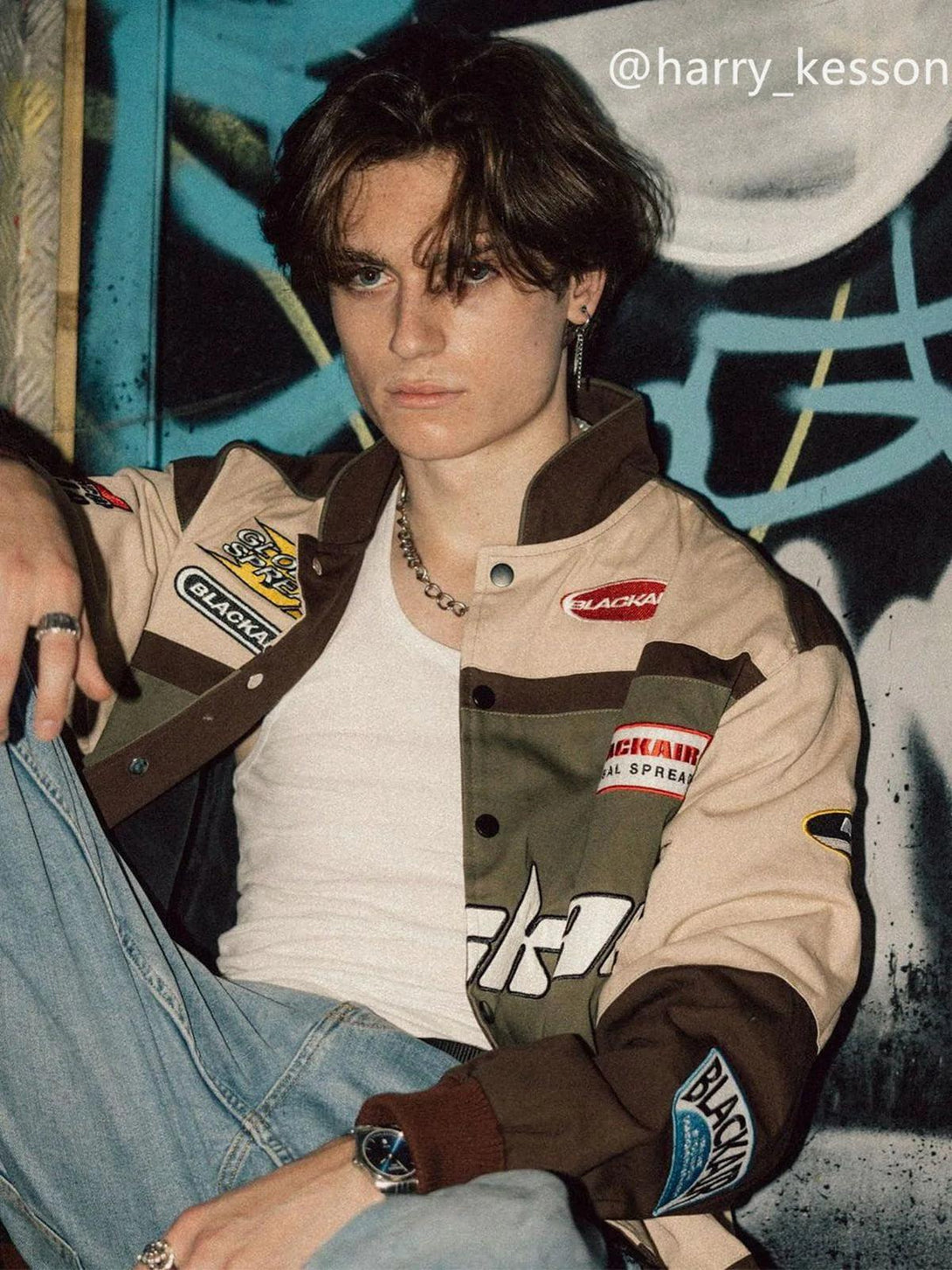 Model in TALISHKO BLACKAIR Motosports Jacket, styled with denim and silver accessories.