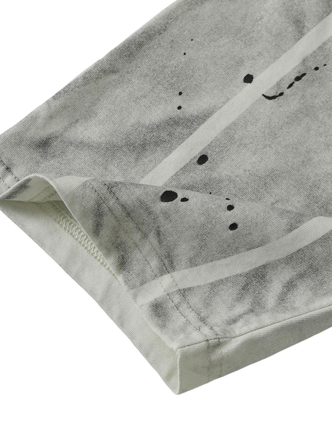 TALISHKO's oversized tie-dye T-shirt sleeve detail, showcasing unique gray patterns and stitching.